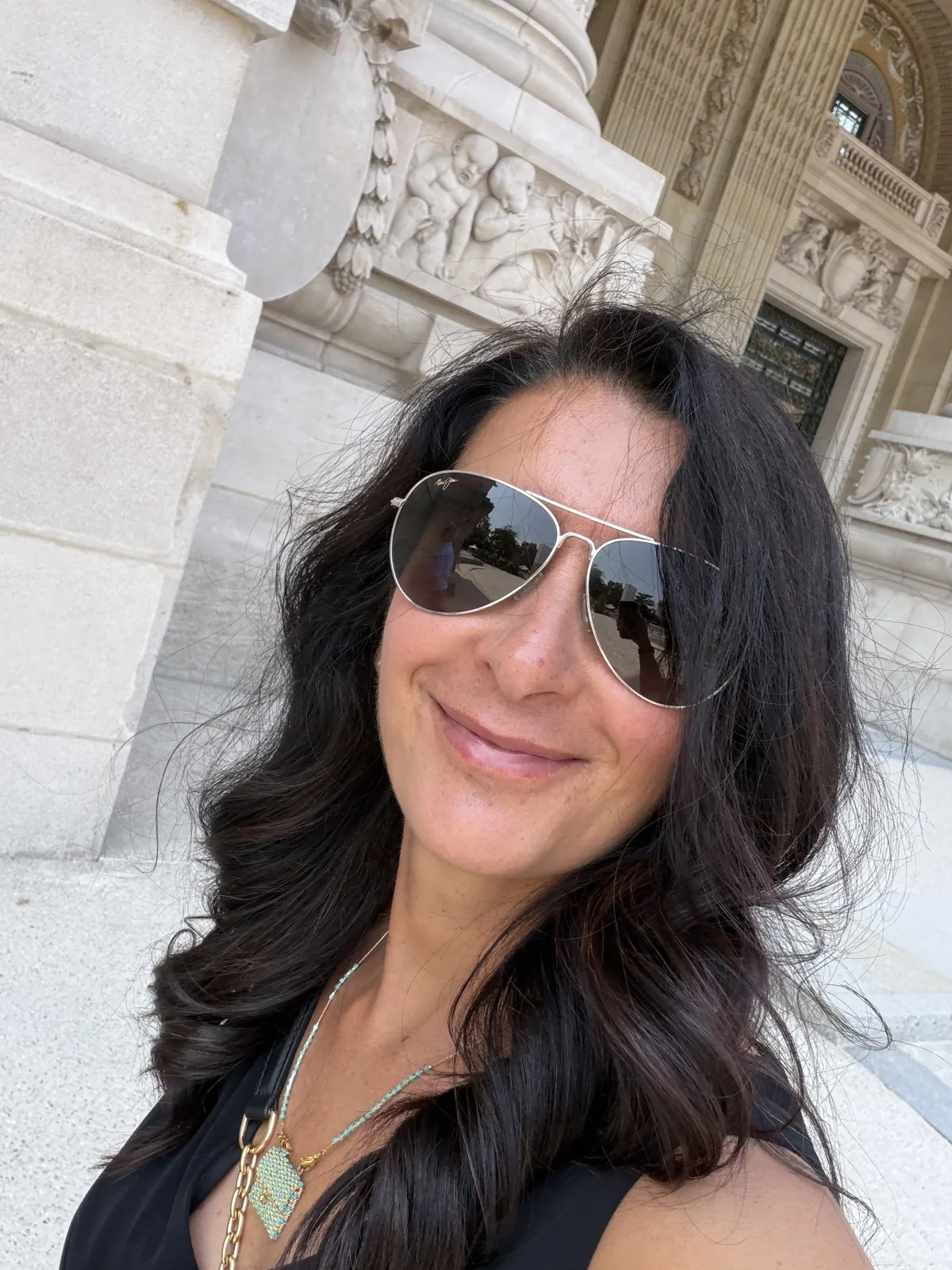 Cris Sgrott smiling outside a stone building
