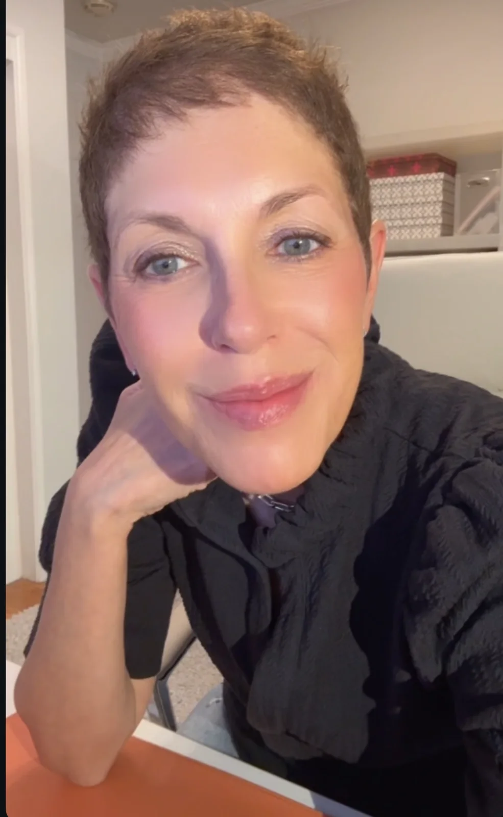 Leslie Josel smiling while seated at a table.