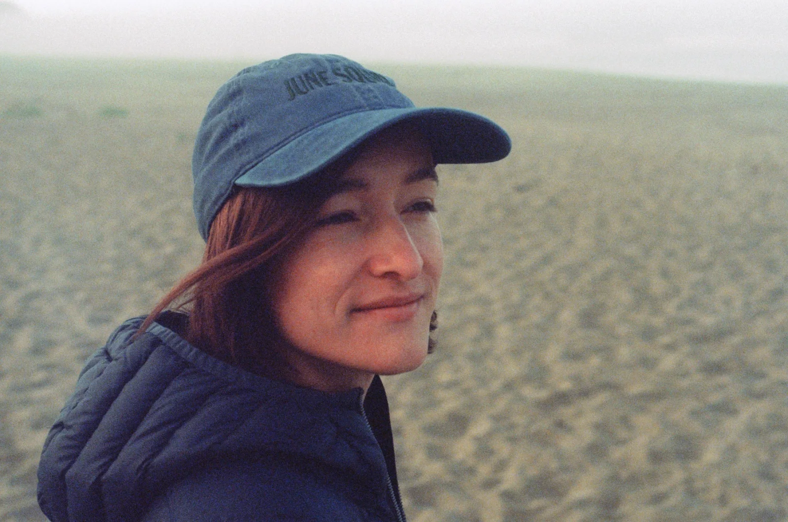 Sarah Teresa Cook outdoors wearing a navy cap and jacket